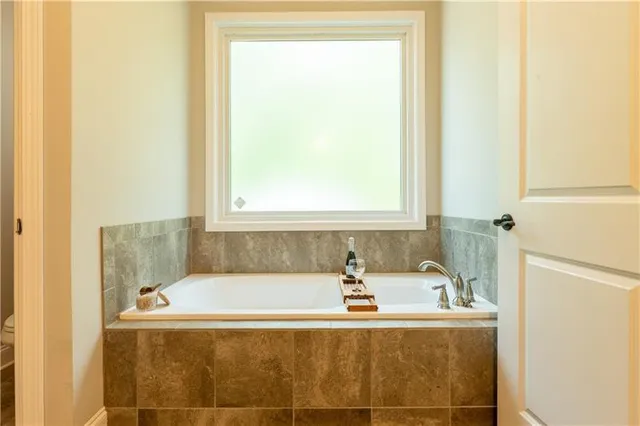 a kitchen with granite countertop a refrigerator stove and microwave