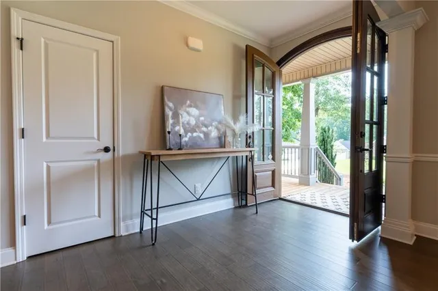 a view of an entryway with wooden floor and door