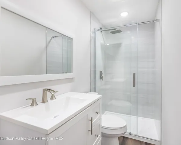 a bathroom with a sink toilet and shower