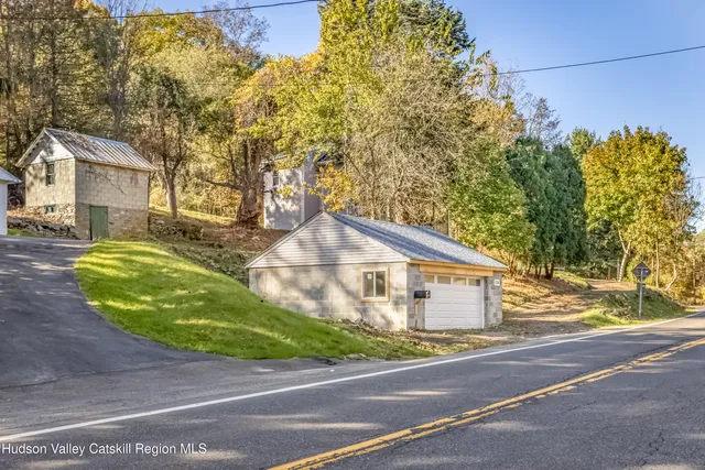 a view of a house with a yard and garage