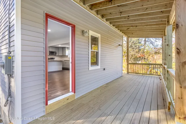 a view of a porch with wooden floor and walls