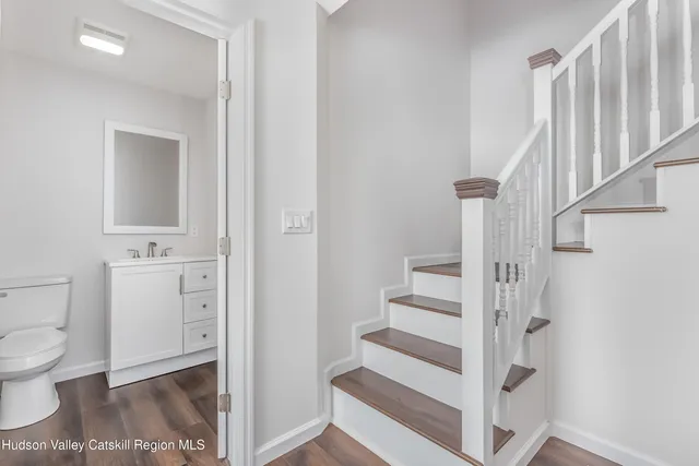 a bathroom with a toilet sink and a mirror