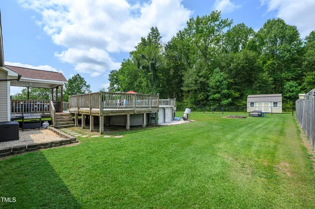 a view of a house with backyard porch and sitting area