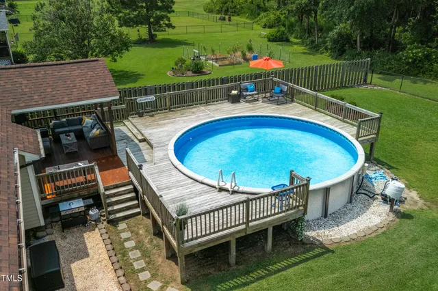 an outdoor sitting area with furniture and garden