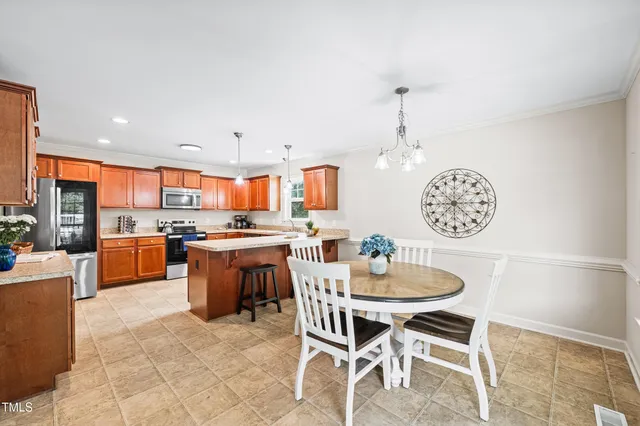 a large kitchen with a table and chairs
