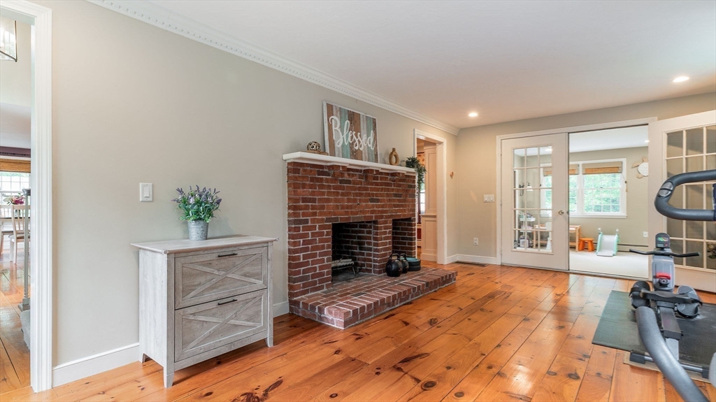 142 Baker Street Walpole, MA 02081 - Photo 22 of 42 a living room with furniture windows and a fireplace