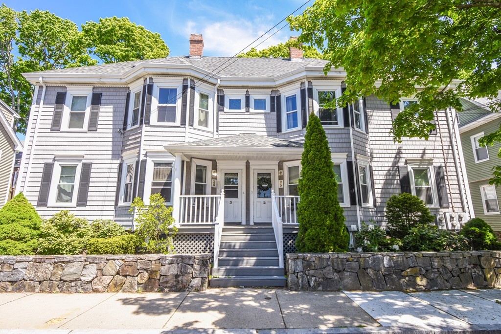 25 Wellington Street, Unit 1 Waltham, MA 02451 - Photo 1 of 18 a front view of a house with a yard