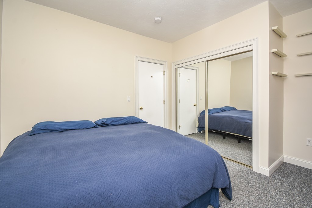 25 Wellington Street, Unit 1 Waltham, MA 02451 - Photo 13 of 18 a bedroom with a bed and a closet