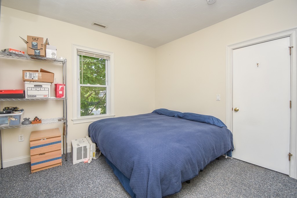 25 Wellington Street, Unit 1 Waltham, MA 02451 - Photo 14 of 18 a bedroom with a bed and a window