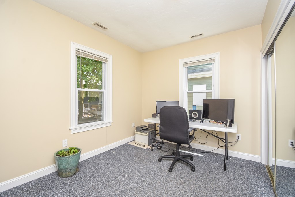 25 Wellington Street, Unit 1 Waltham, MA 02451 - Photo 15 of 18 a view of a workspace with furniture and a window
