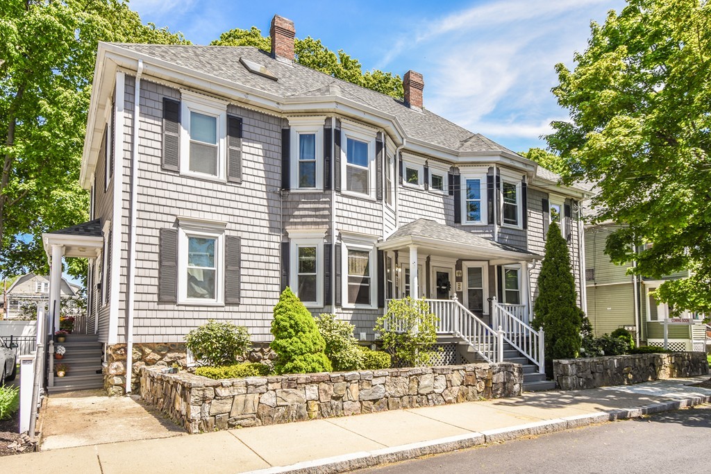 25 Wellington Street, Unit 1 Waltham, MA 02451 - Photo 2 of 18 a front view of a house with a yard