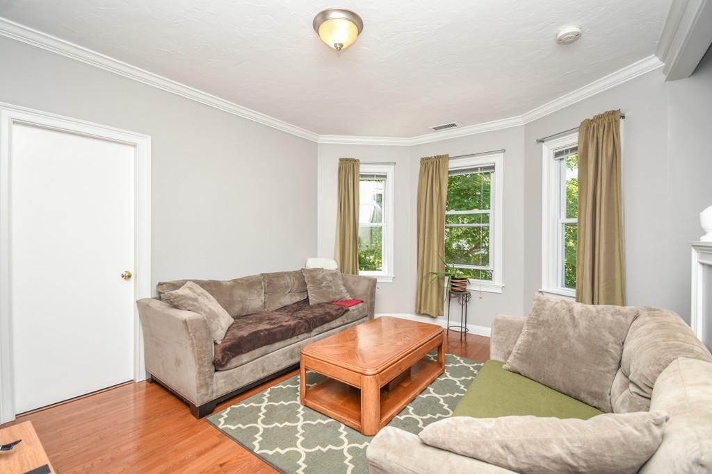 25 Wellington Street, Unit 1 Waltham, MA 02451 - Photo 7 of 18 a living room with furniture and a large window