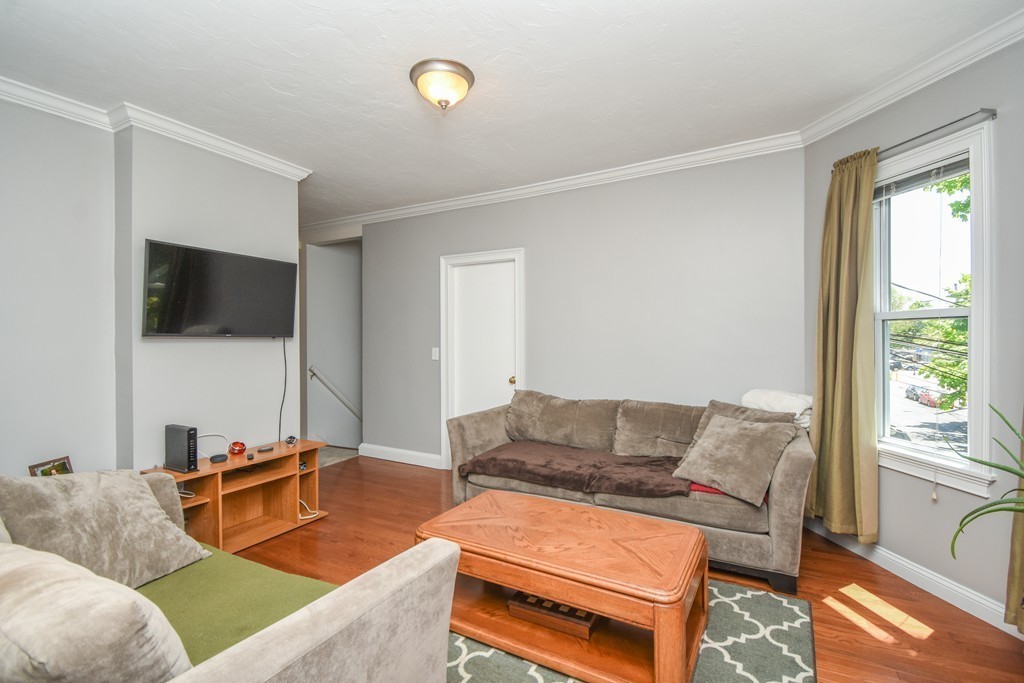 25 Wellington Street, Unit 1 Waltham, MA 02451 - Photo 8 of 18 a living room with furniture and a flat screen tv