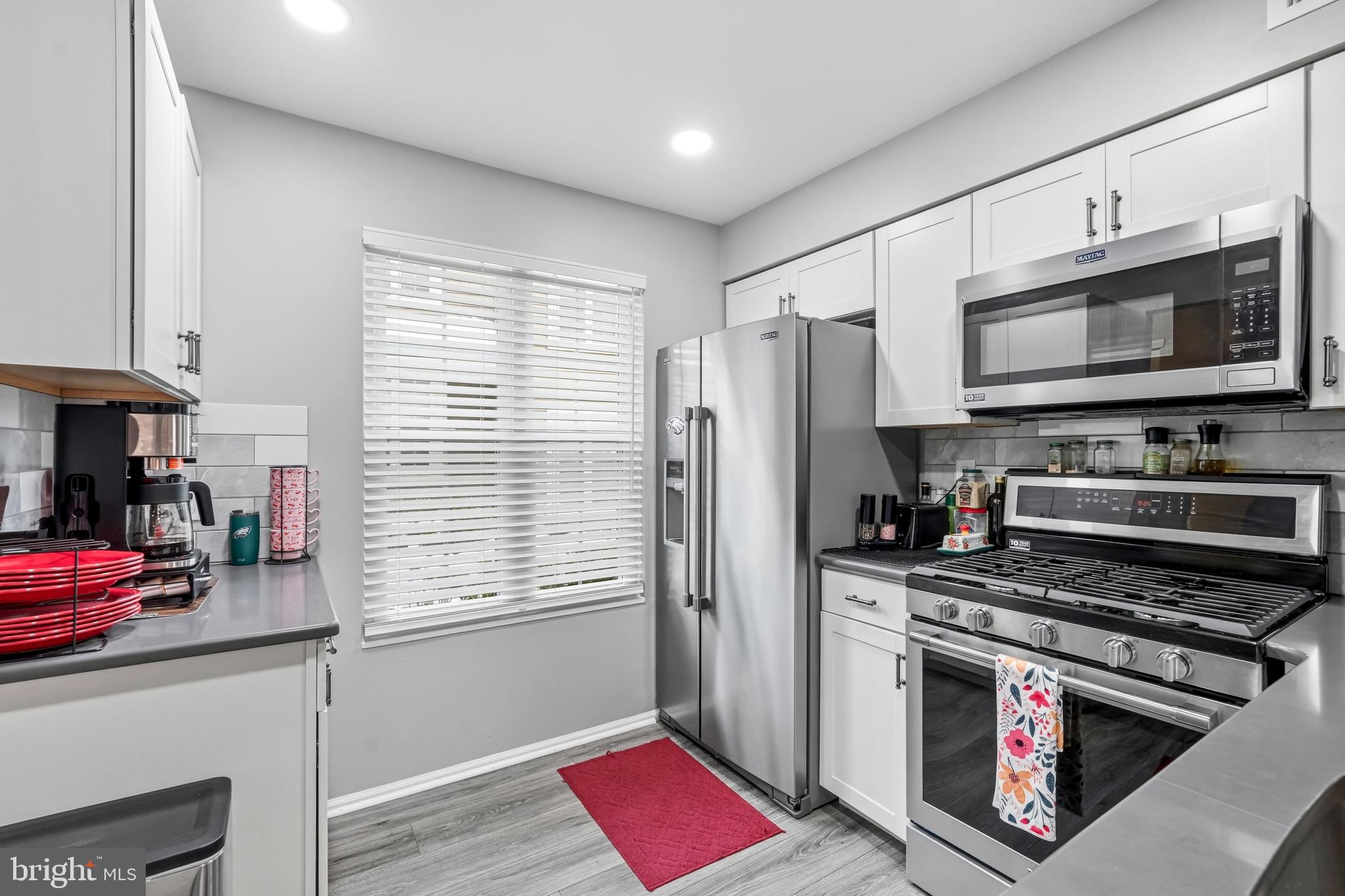 2705A Heatherstone Court Mount Laurel, NJ 08054 - Photo 8 of 29 a kitchen with stainless steel appliances a stove microwave and a refrigerator
