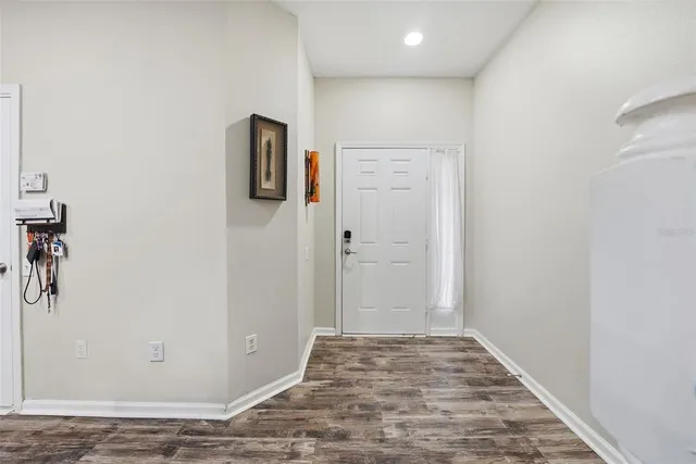 a view of a hallway with wooden floor and a hallway