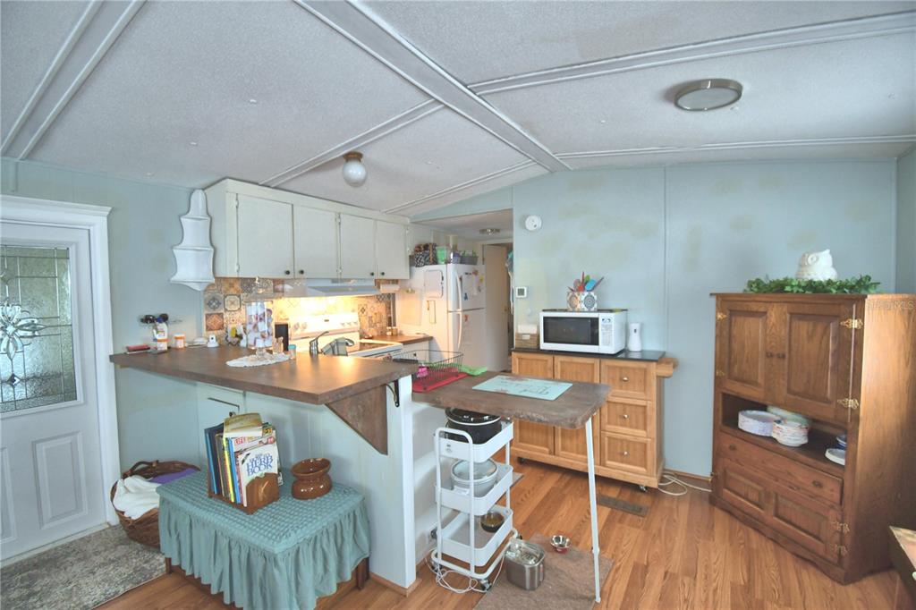 251 Patterson Road, Unit D35 Haines City, FL 33844 - Photo 16 of 37 a dining room with furniture and wooden floor