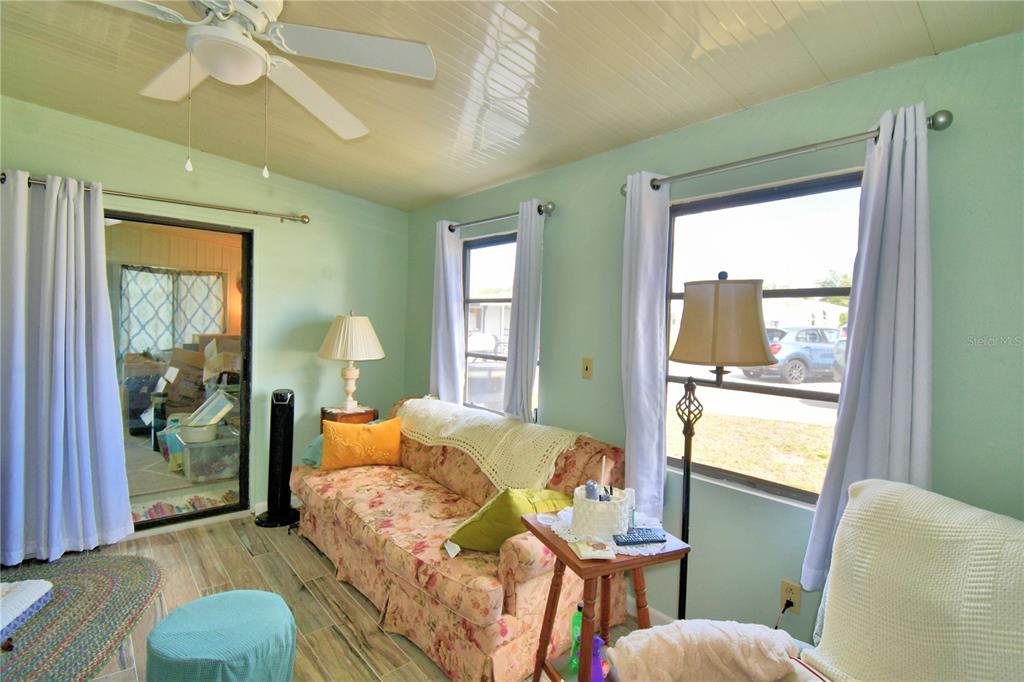 251 Patterson Road, Unit D35 Haines City, FL 33844 - Photo 7 of 37 a bedroom with a bed and wooden floor