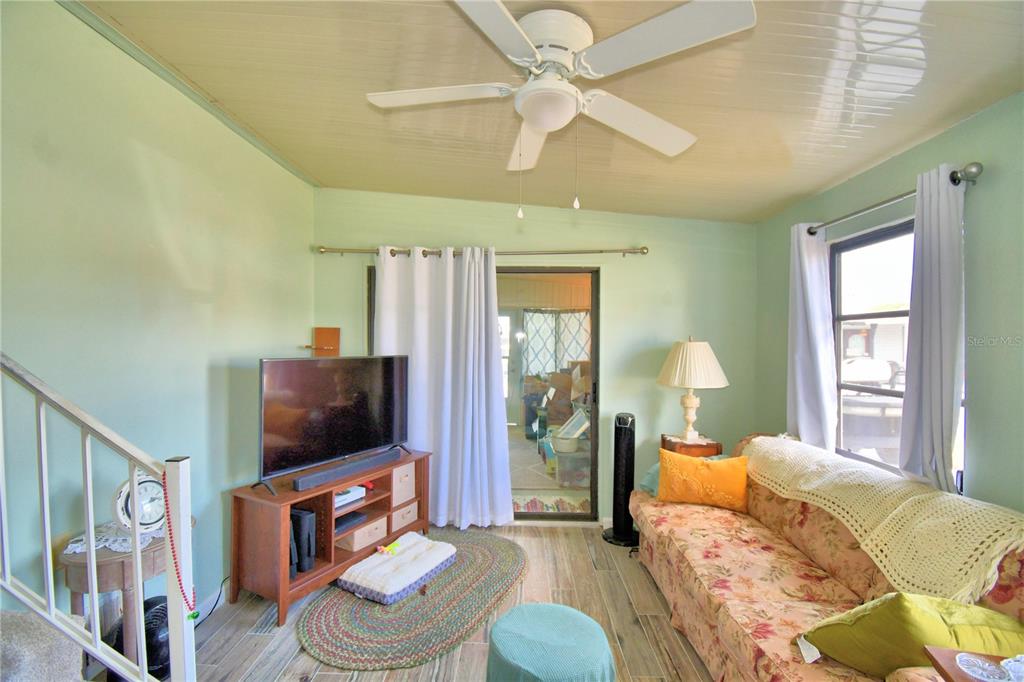 251 Patterson Road, Unit D35 Haines City, FL 33844 - Photo 8 of 37 a living room with furniture a flat screen tv and a window