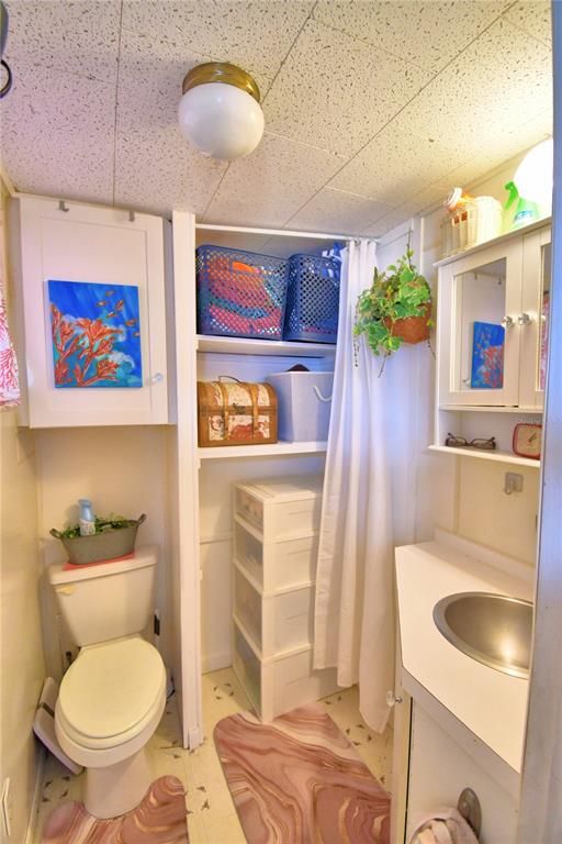 251 Patterson Road, Unit D35 Haines City, FL 33844 - Photo 10 of 37 a bathroom with a toilet sink and mirror