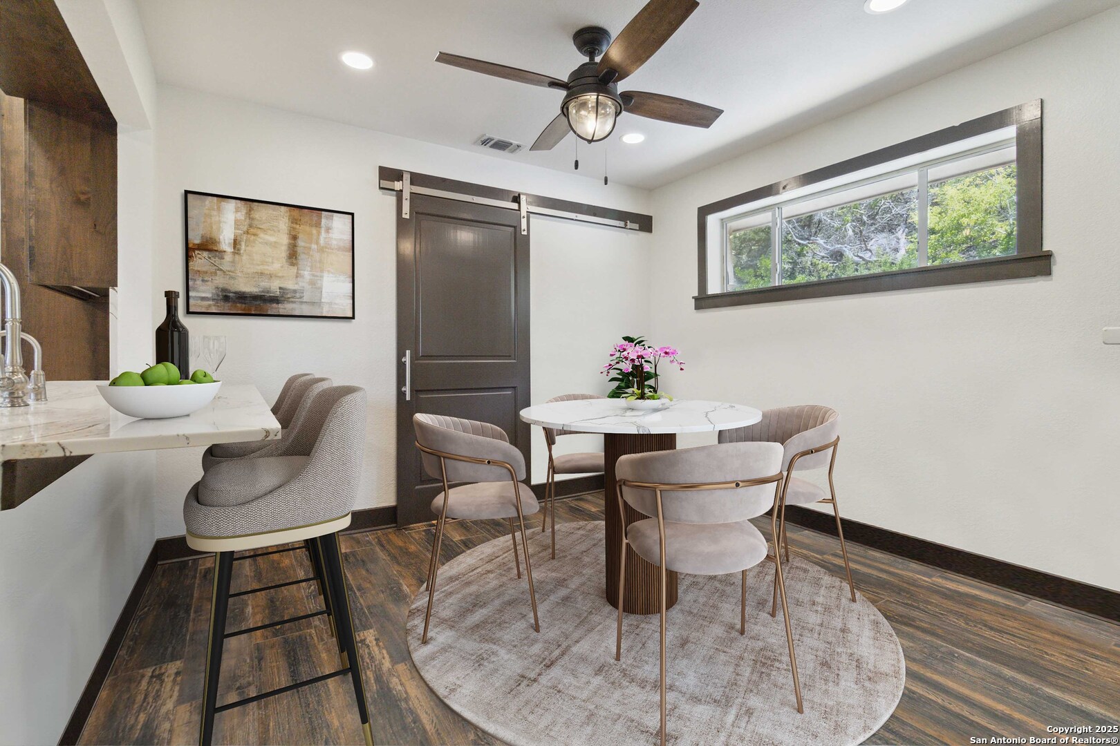 3293 North Little Creek Road Utopia, TX 78884 - Photo 26 of 65 a dining room with furniture a rug and wooden floor