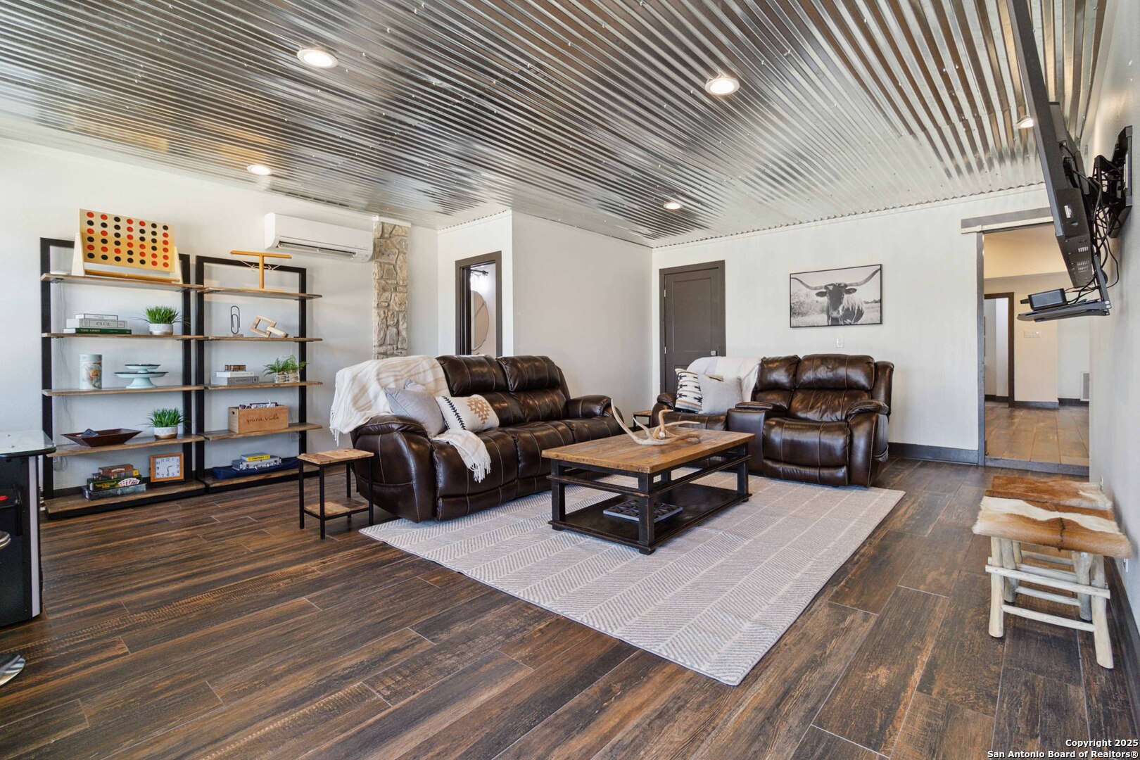 3293 North Little Creek Road Utopia, TX 78884 - Photo 27 of 65 a living room with furniture a rug and a bookshelf
