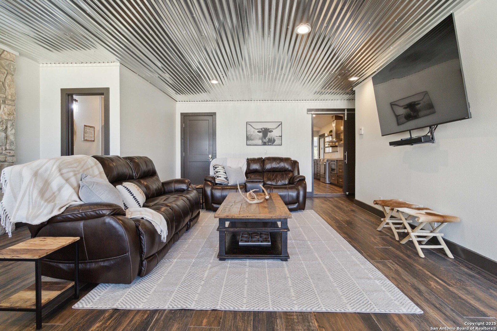3293 North Little Creek Road Utopia, TX 78884 - Photo 28 of 65 a living room with furniture a flat screen tv and kitchen view