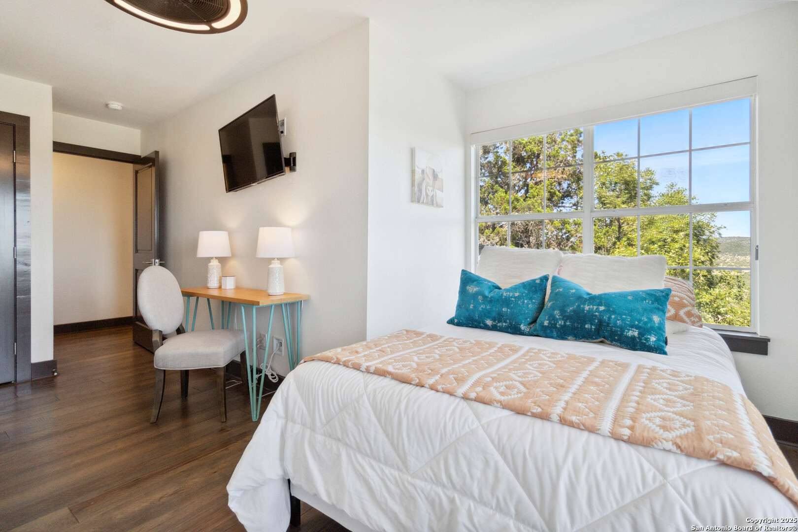 3293 North Little Creek Road Utopia, TX 78884 - Photo 32 of 65 a bedroom with a bed and a chair