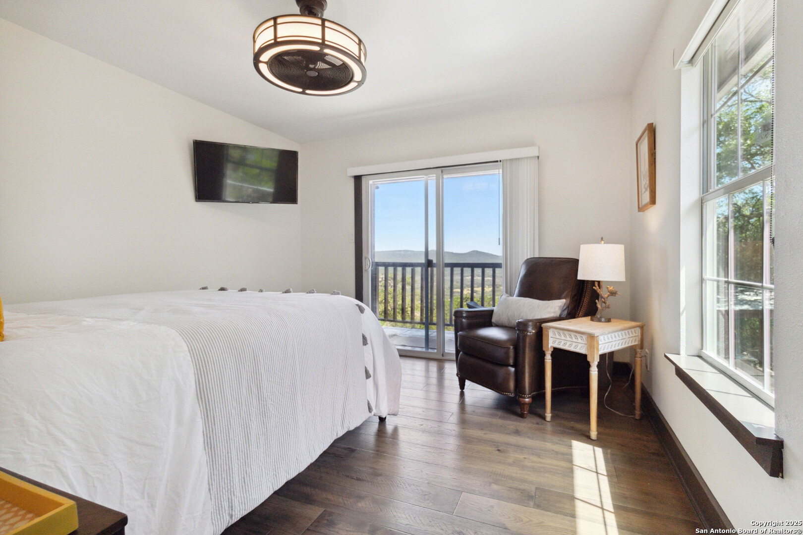 3293 North Little Creek Road Utopia, TX 78884 - Photo 33 of 65 a bedroom with a bed and a flat screen tv