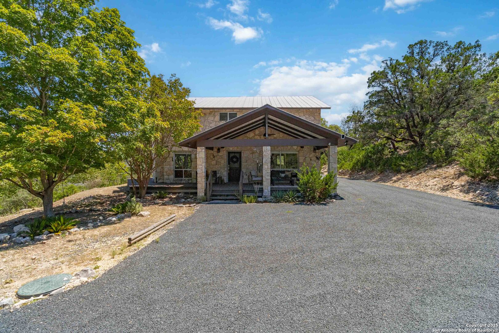 3293 North Little Creek Road Utopia, TX 78884 - Photo 37 of 65 a front view of a house with a garden