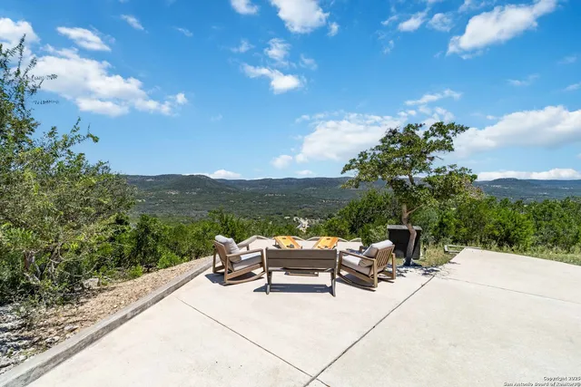 an aerial view of residential houses with outdoor space and trees