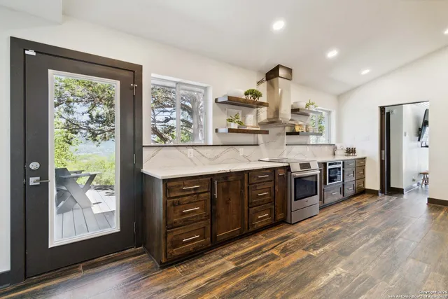 a kitchen with stainless steel appliances granite countertop a stove and a refrigerator