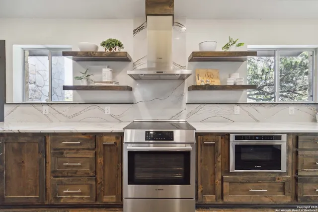 a kitchen with stainless steel appliances a stove and a cabinets