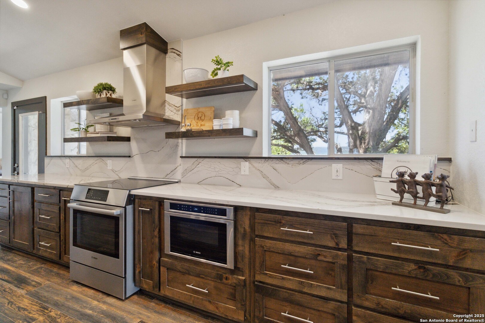 3293 North Little Creek Road Utopia, TX 78884 - Photo 7 of 65 a kitchen with stainless steel appliances a stove and cabinets