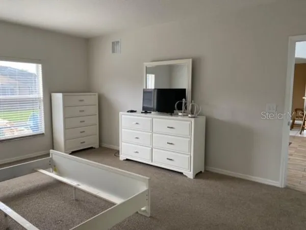 a room with cabinets and flat screen tv