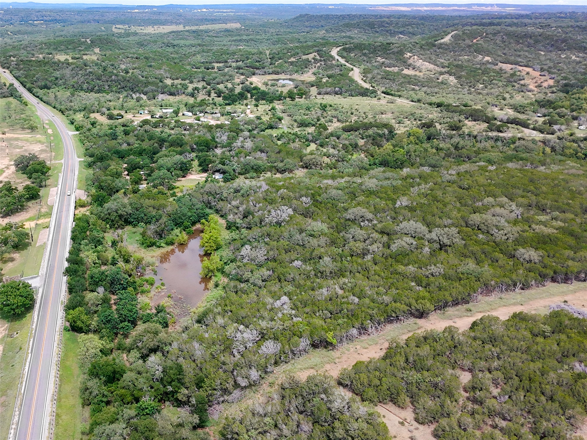 5200 Ranch To Market 1431 Marble Falls, TX 78654 - Photo 25 of 38 a view of a green field with lots of bushes