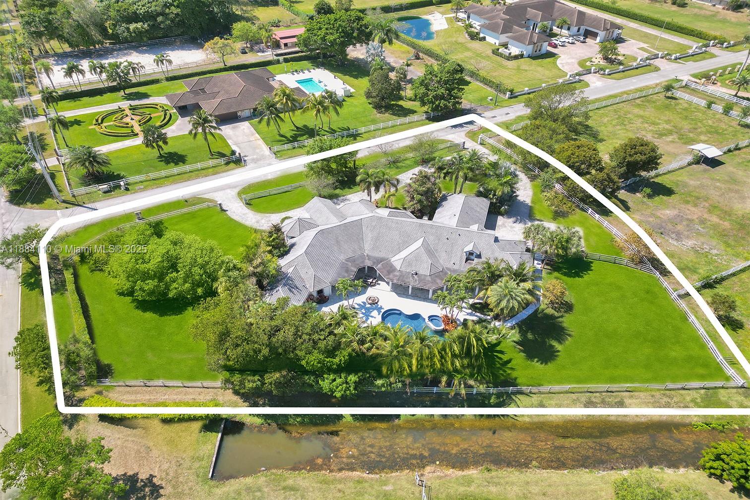 17801 Southwest 50th Street Southwest Ranches, FL 33331 - Photo 42 of 45 an aerial view of a swimming pool with a yard