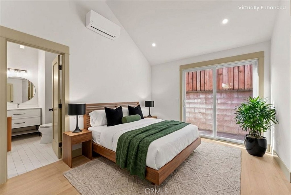 a bedroom with a large bed and a potted plant