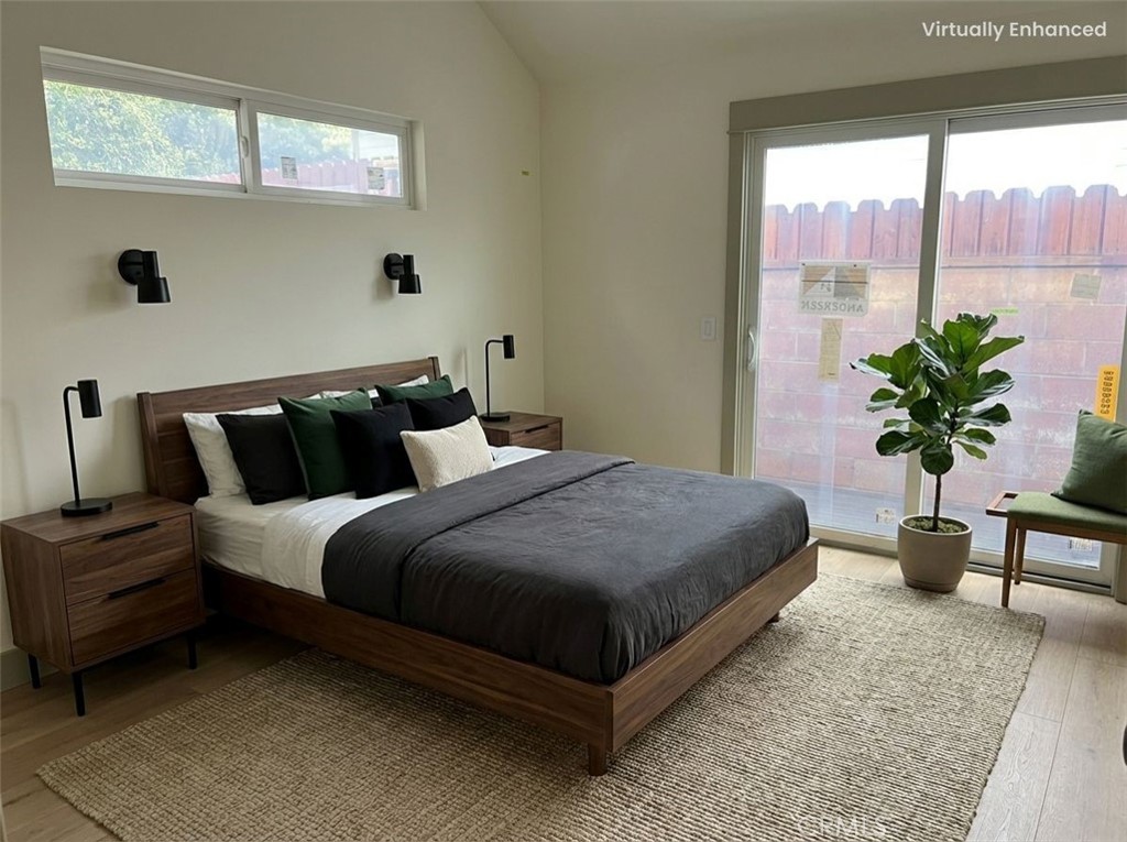 5409 Magnolia Avenue Riverside, CA 92506 - Photo 12 of 20 a bedroom with a large bed and a potted plant