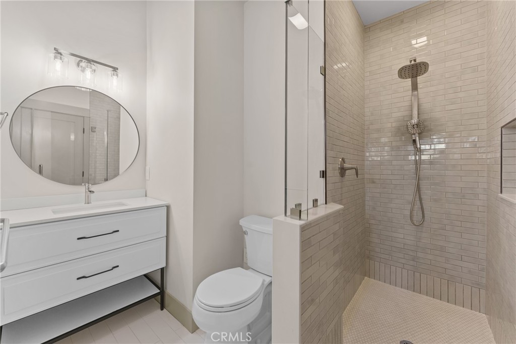 5409 Magnolia Avenue Riverside, CA 92506 - Photo 17 of 20 a bathroom with a sink a toilet and shower