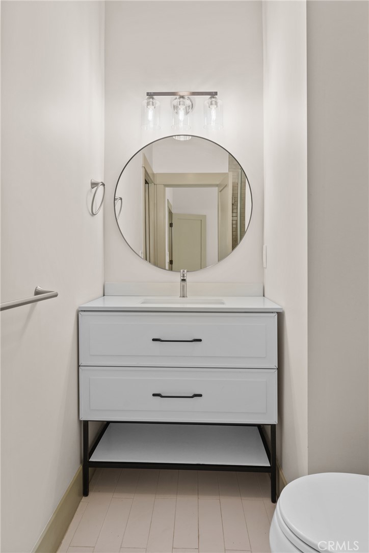 5409 Magnolia Avenue Riverside, CA 92506 - Photo 17 of 21 a bathroom with a sink mirror vanity and toilet