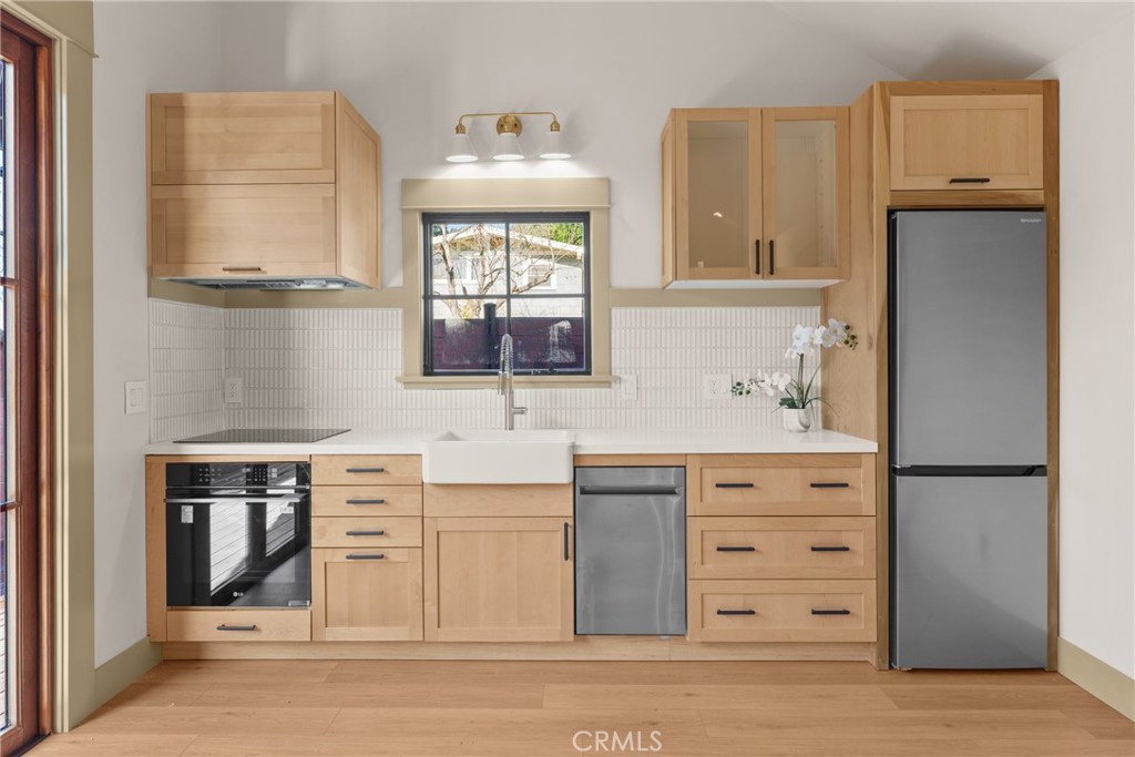 5409 Magnolia Avenue Riverside, CA 92506 - Photo 3 of 20 a kitchen with cabinets appliances and a window