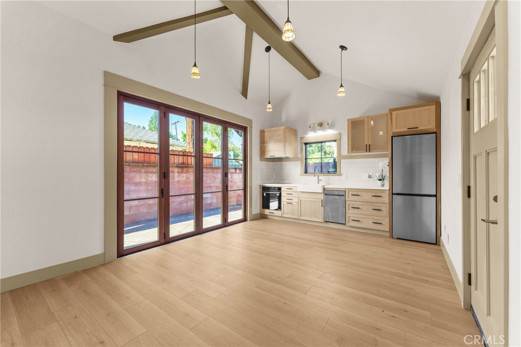 5409 Magnolia Avenue Riverside, CA 92506 - Photo 5 of 20 a view of a kitchen with stainless steel appliances wooden floor and a window