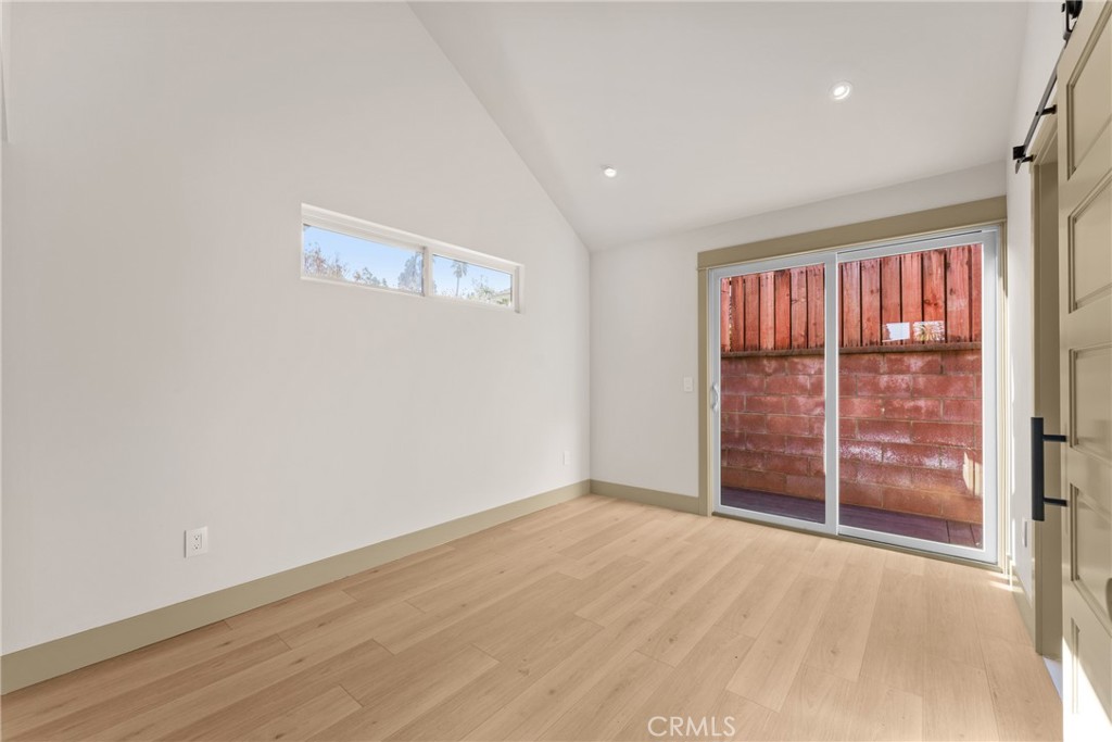 5409 Magnolia Avenue Riverside, CA 92506 - Photo 8 of 20 an empty room with wooden floor and windows