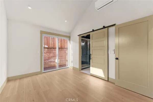 an empty room with windows and closet