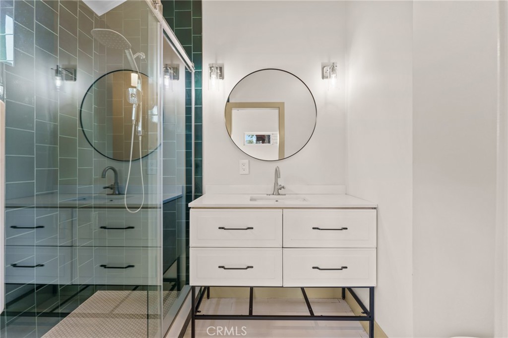 5409 Magnolia Avenue Riverside, CA 92506 - Photo 10 of 20 a bathroom with a sink mirror and vanity
