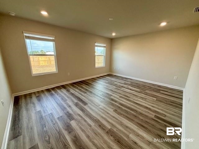 22215 Aleutian Avenue Foley, AL 36535 - Photo 11 of 34 Empty room with dark hardwood / wood-style floors