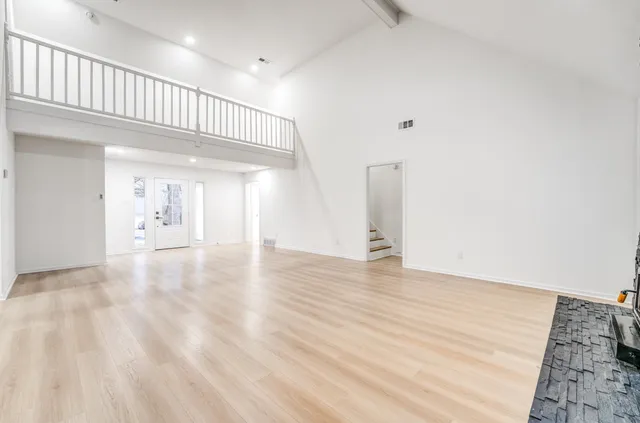a view of a hallway with wooden floor