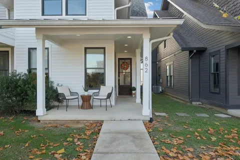 a view of a patio with table and chairs