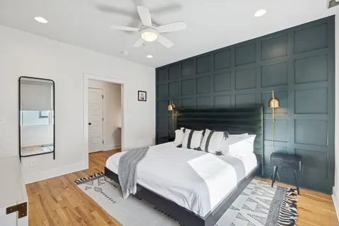 a bedroom with a bed and a mirror