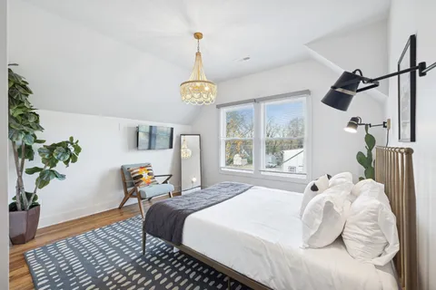 a bedroom with a bed and window